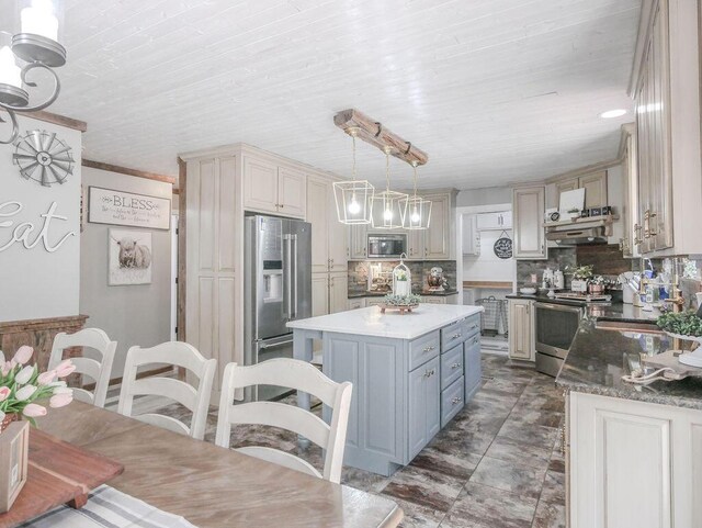 kitchen with dark stone counters, stainless steel electric stove, a sink, decorative backsplash, and cream cabinetry