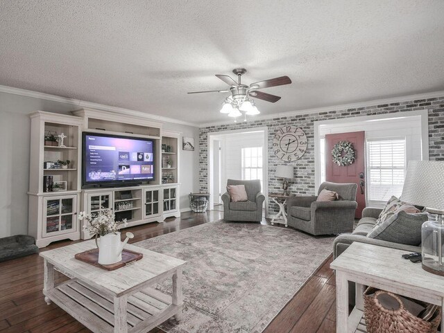 living room featuring a wealth of natural light, dark wood-style floors, and ornamental molding