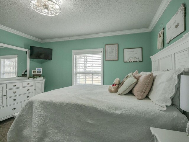 bedroom featuring a textured ceiling, dark colored carpet, and ornamental molding