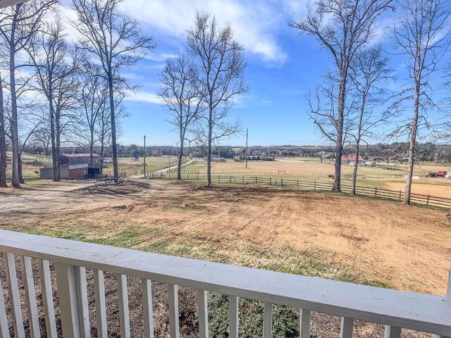 view of yard featuring a rural view and fence