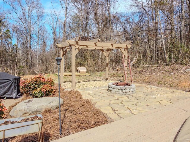 view of patio with a pergola and an outdoor fire pit