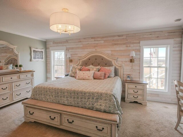 bedroom featuring an inviting chandelier, crown molding, carpet, and a textured ceiling