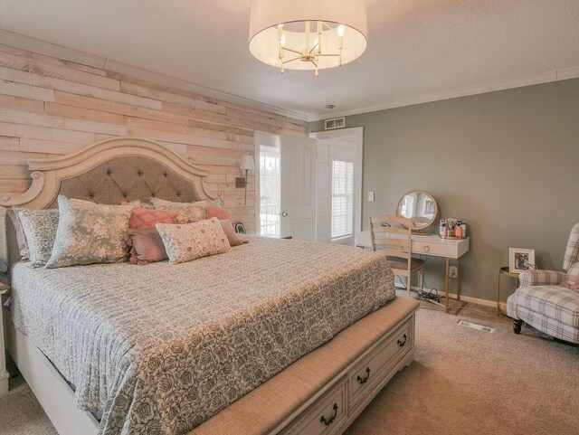 bedroom with ornamental molding, a textured ceiling, carpet, wood walls, and baseboards