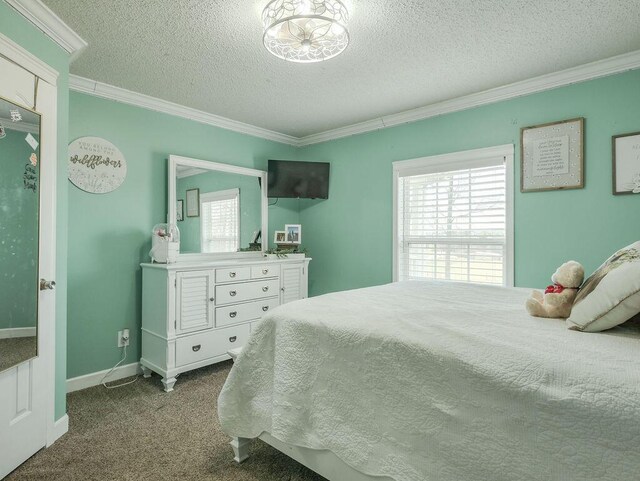 bedroom featuring a textured ceiling, carpet flooring, baseboards, and ornamental molding