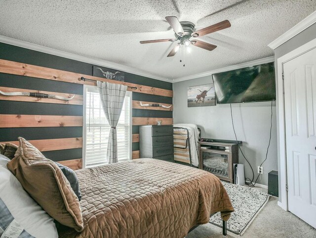 carpeted bedroom with a textured ceiling, ornamental molding, and a ceiling fan