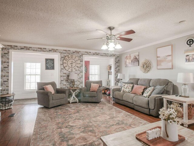 living room with crown molding, dark wood-style floors, and arched walkways