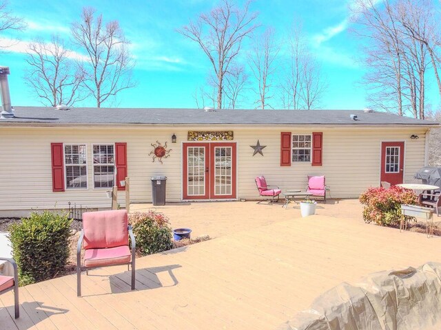 rear view of property with french doors and a wooden deck