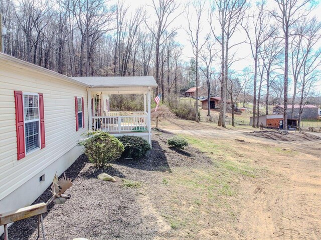 view of yard featuring covered porch