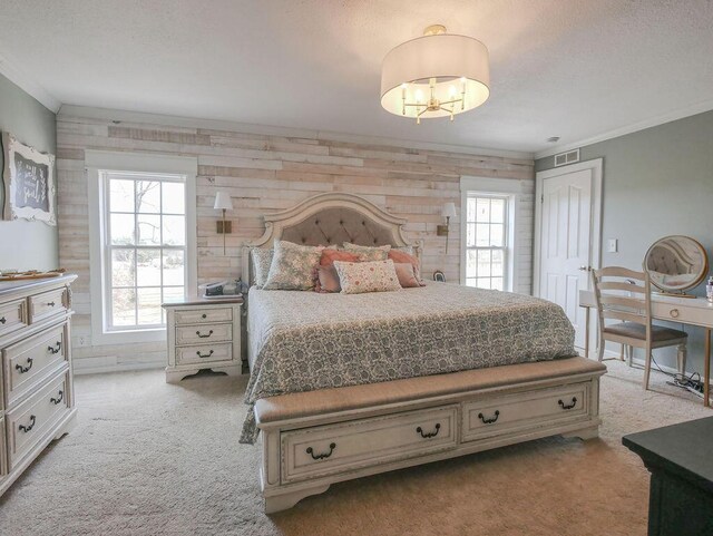 bedroom featuring visible vents, light colored carpet, and ornamental molding