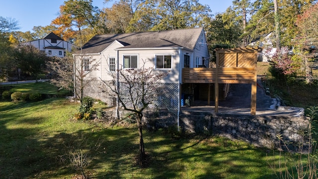 rear view of property with a deck and a lawn