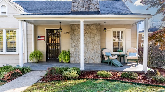 view of exterior entry featuring covered porch