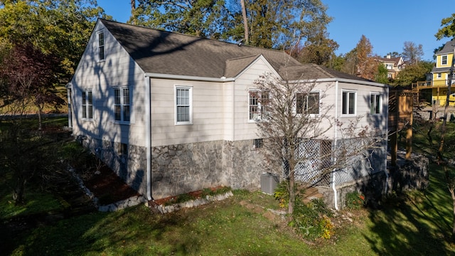 view of property exterior with a yard