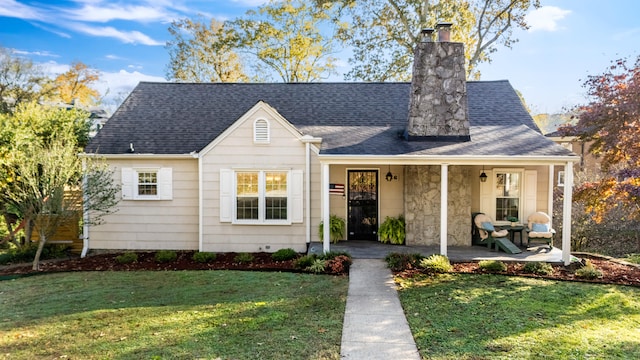 view of front of house with a front yard and covered porch