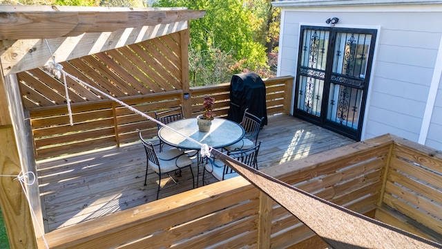 wooden terrace with area for grilling and french doors