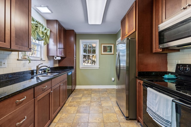 kitchen featuring sink, tasteful backsplash, a wealth of natural light, and black appliances