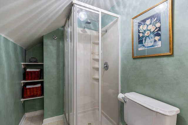 bathroom with tile patterned flooring, toilet, walk in shower, and lofted ceiling