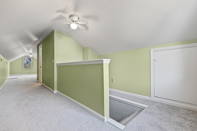 bonus room featuring ceiling fan, light carpet, and vaulted ceiling