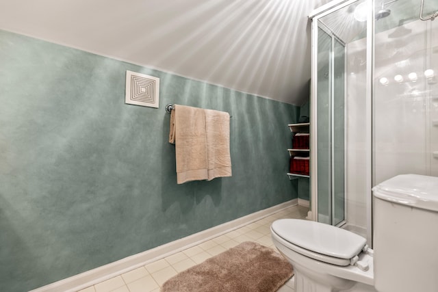 bathroom featuring tile patterned flooring, toilet, and a shower with door