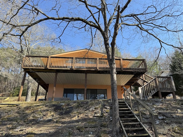 back of property featuring stairway and a wooden deck