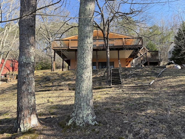 back of house featuring stairway and a wooden deck