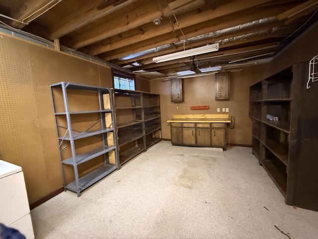 below grade area with washer / clothes dryer and a workshop area