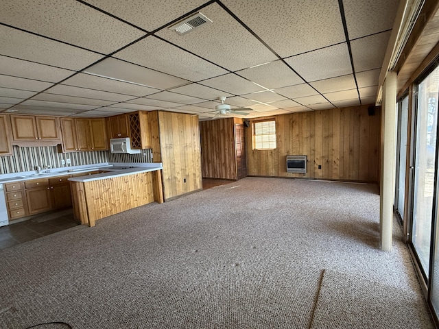 kitchen with white appliances, carpet flooring, visible vents, light countertops, and heating unit