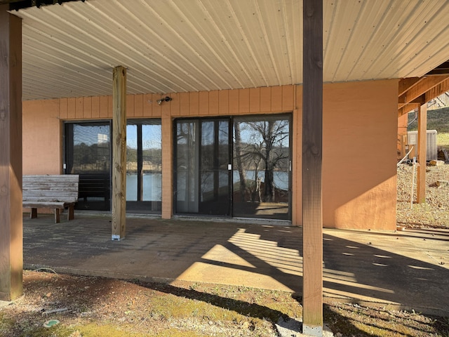 entrance to property with central AC unit and a patio