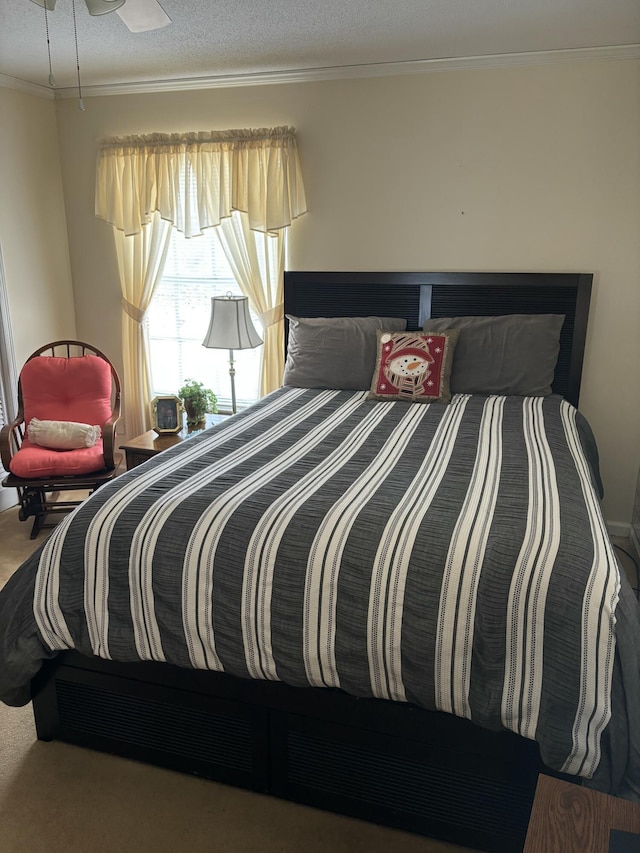 bedroom with carpet floors, a textured ceiling, and crown molding