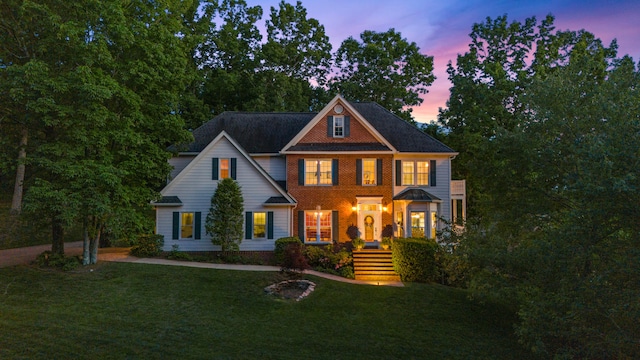 colonial home with a lawn