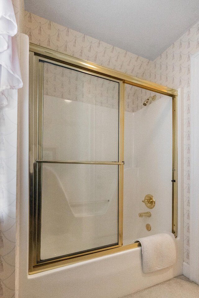 bathroom featuring shower / bath combination with glass door