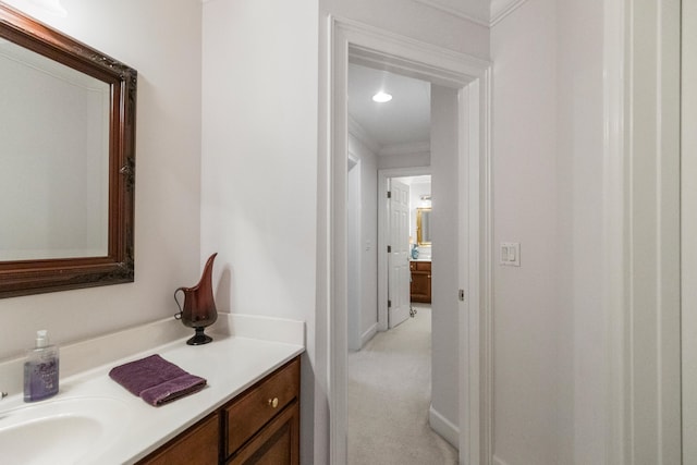 bathroom with vanity and ornamental molding