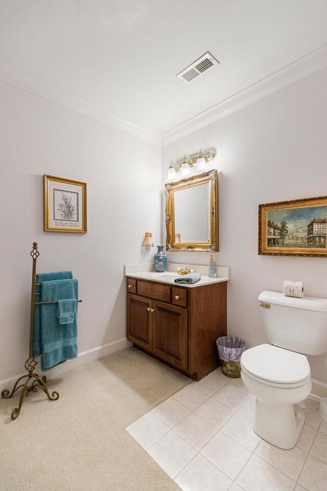 bathroom featuring tile patterned flooring, vanity, toilet, and ornamental molding