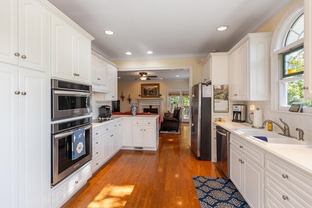 kitchen featuring white cabinets, a wealth of natural light, sink, and appliances with stainless steel finishes