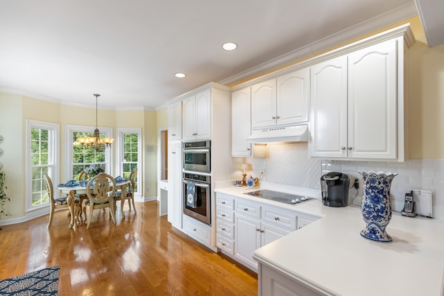 kitchen with white electric cooktop, white cabinets, custom range hood, and light wood-type flooring