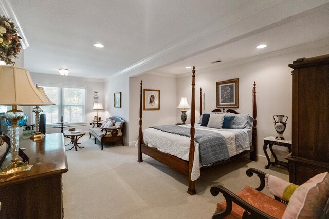 bedroom with crown molding and light colored carpet