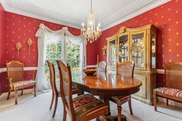 carpeted dining room with crown molding and an inviting chandelier