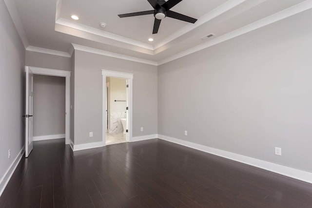 unfurnished bedroom with connected bathroom, dark hardwood / wood-style floors, ornamental molding, a raised ceiling, and ceiling fan