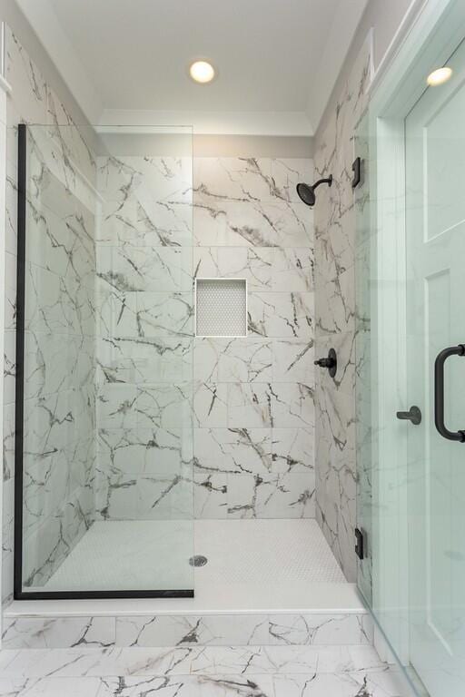 bathroom with walk in shower and crown molding