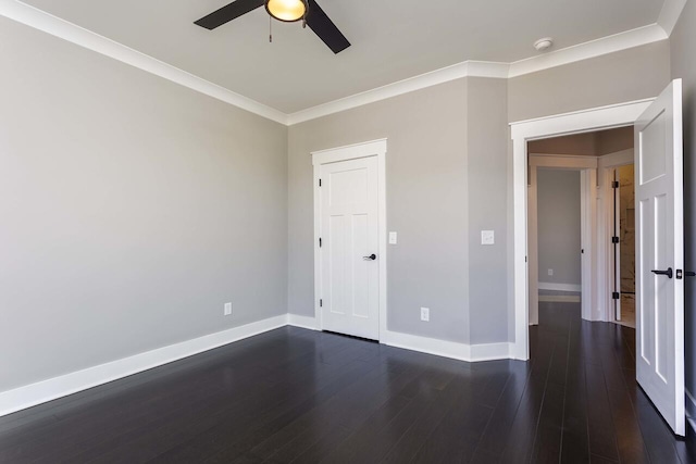 empty room featuring ceiling fan, dark hardwood / wood-style flooring, and ornamental molding