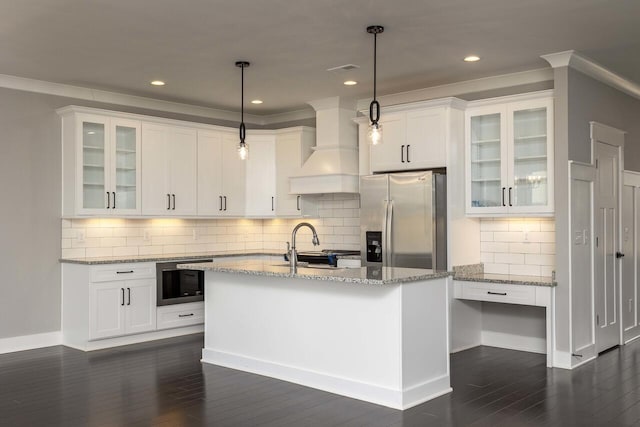 kitchen featuring premium range hood, white cabinetry, stainless steel refrigerator with ice dispenser, built in microwave, and pendant lighting