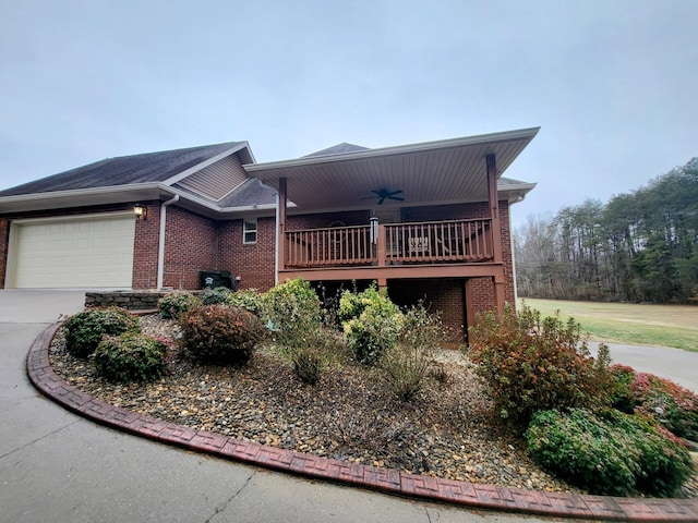 view of property exterior with a garage and ceiling fan