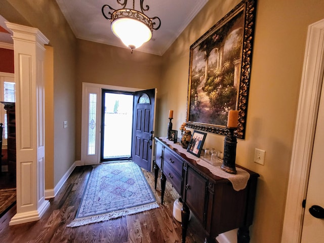 entrance foyer with crown molding, dark hardwood / wood-style flooring, and decorative columns