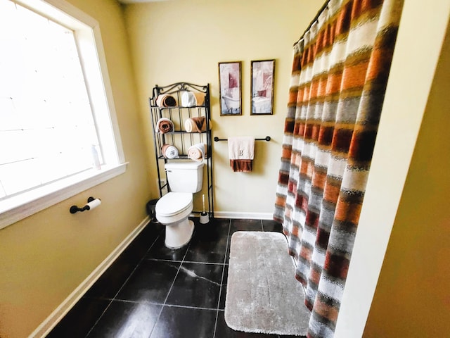 bathroom featuring toilet and tile patterned flooring