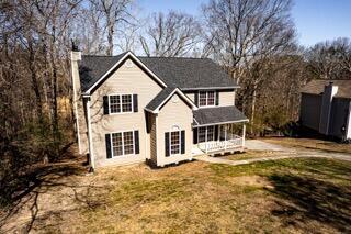 view of front of property with a front lawn and a chimney