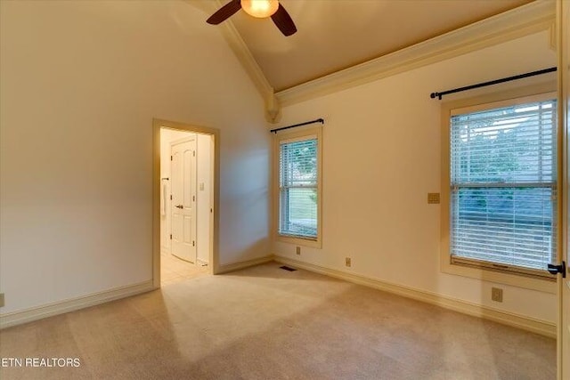 carpeted spare room featuring ornamental molding, high vaulted ceiling, and ceiling fan