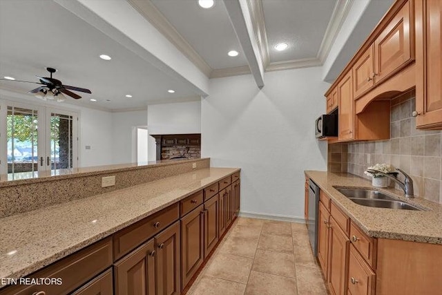 kitchen featuring crown molding, light stone countertops, and sink