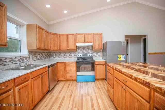 kitchen featuring appliances with stainless steel finishes, light wood-type flooring, backsplash, vaulted ceiling, and crown molding