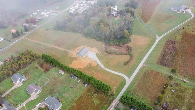 birds eye view of property with a rural view