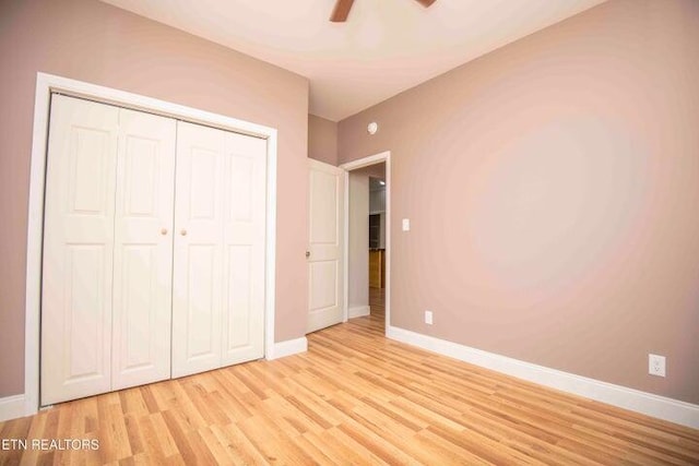 unfurnished bedroom with a closet, ceiling fan, and light hardwood / wood-style flooring