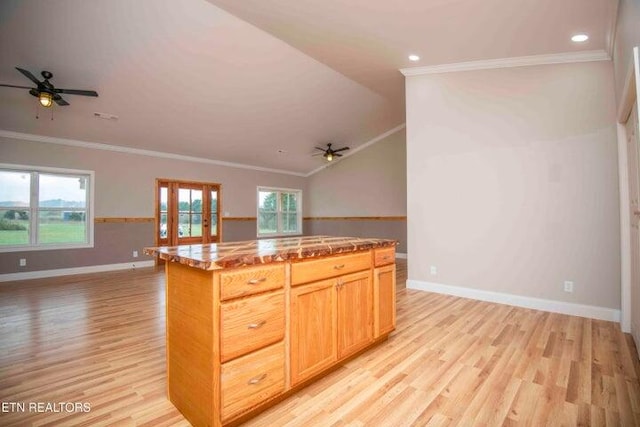 kitchen featuring crown molding, light hardwood / wood-style flooring, and a kitchen island